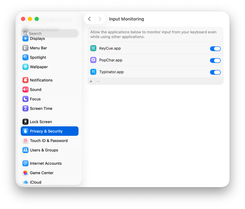 Screenshot of macOS System Settings in the ‘Privacy & Security’ section, showing the ‘Input Monitoring’ panel. A list of apps (KeyCue.app, PopChar.app, and Typinator.app) is displayed with toggle switches enabled, allowing them to monitor keyboard input. The left sidebar shows other settings categories such as Displays, Notifications, Sound, and Users & Groups.
